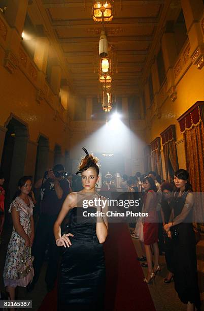 Model displays creations during the fashion show of Italy jewellery brand AMA, at the Museum of Imperial Palace of Manchu State, the official...