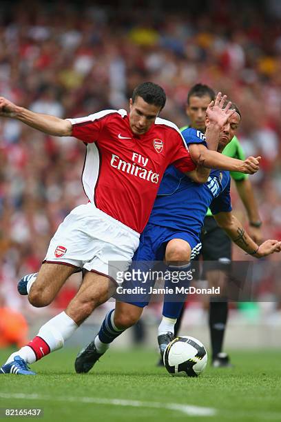 Robin Van Persie of Arsenal competes for the ball with Guti of Real Madrid during the pre-season friendly match between Arsenal and Real Madrid...