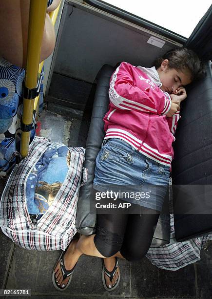 Refugee from a maverick Georgian region of South Ossetia sleeps in a bus upon arrival to Russian territory in a village of Tamisk, some 50 kilometers...
