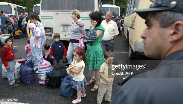 Refugees from a maverick Georgian region of South Ossetia leave buses upon arrival to Russian territory in a village of Tamisk, some 50 kilometers...