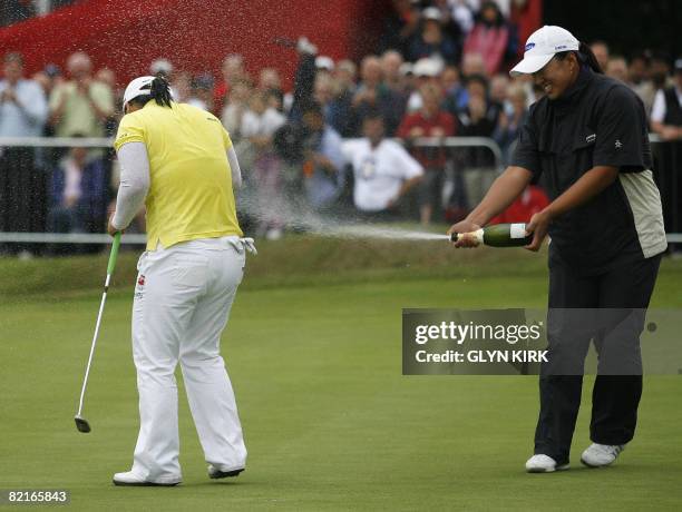 Korean golfer Ji-Yai Shin is sprayed with champagne by compatriot Amy Yang on the 18th green after winning a final round of the Ricoh Women's British...