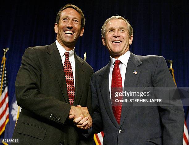 This July 29, 2002 file photo shows US President George W. Bush shaking hands with Mark Sanford at the North Charleston Convention Center 29 July...
