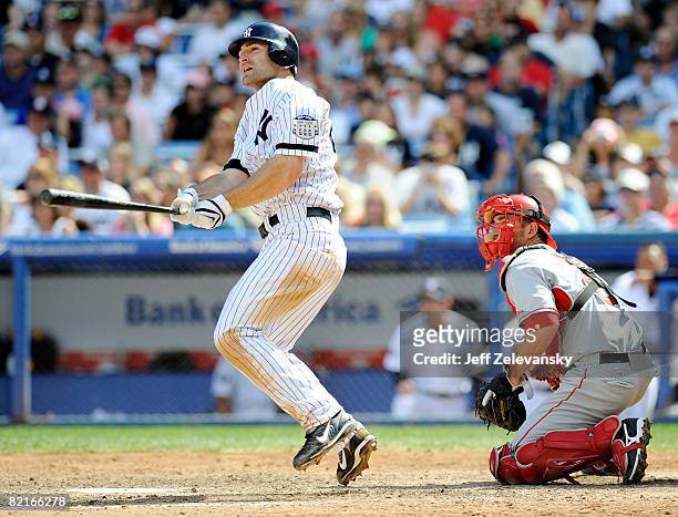 Xavier Nady of the New York Yankees watches his three-run home run in front of Jeff Mathis the Los Angeles Angels of Anaheim on August 3, 2008 at...