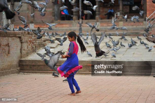 Nepalese devotee play with peigon after offering ritual prayer during Shrawan Sombar festival at the premises of Pashupatinath Temple, Kathmandu,...
