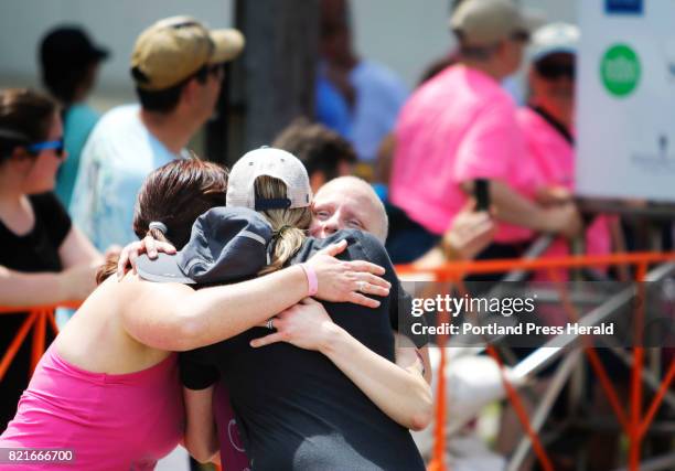 Amanda Benoit of Saco hugs teammates Johanna Dicianni and Karen Gellis, also of Saco, at the finish line at the 10th annual Tri for a Cure triathlon...