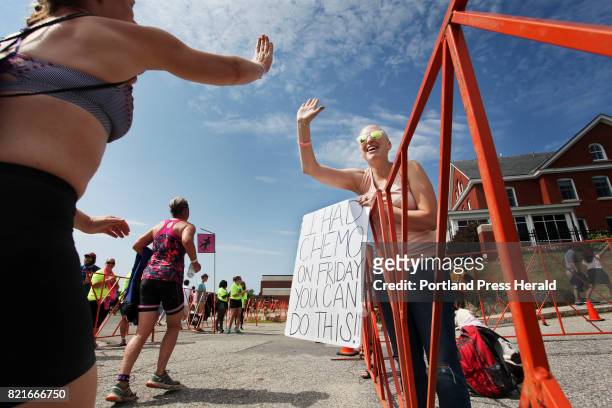 Cancer patient Sarah Emerson of Westbrook cheers on participants at the 10th annual Tri for a Cure triathlon at SMCC.