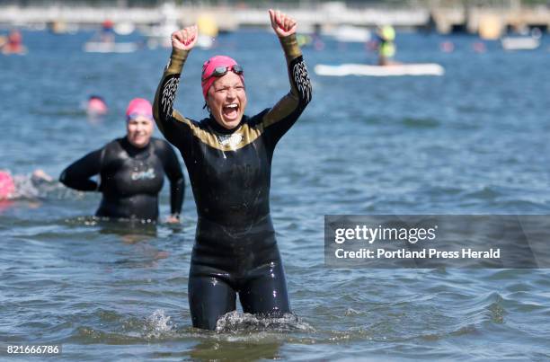 Jessica Jordan of Cape Elizabeth celebrates as she emerges from the water at the 10th annual Tri for a Cure triathlon at SMCC.