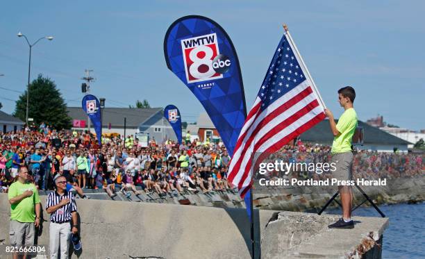 The national anthem is played at the start of the 10th annual Tri for a Cure triathlon at SMCC.