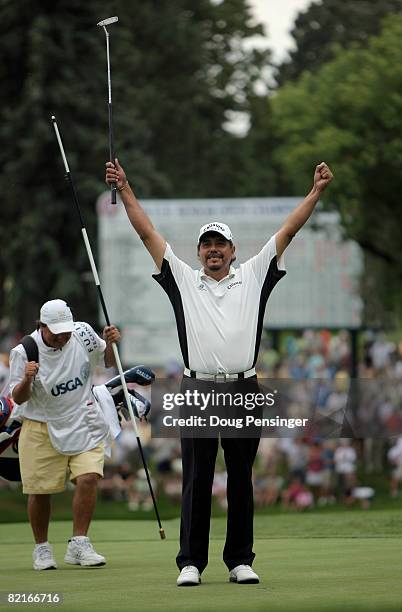 Edurado Romero of Argentina celebrates with caddy Alejandro Molina after dropping the final putt in the final round to win the 2008 US Senior Open...