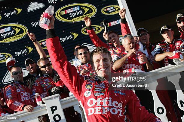 Carl Edwards, driver of the Office Depot Ford, celebrates in Victory Lane after winning the NASCAR Sprint Cup Series Sunoco Red Cross Pennsylvania...