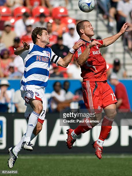 Forward Chad Barrett of Toronto FC leaps for the ball with defender Drew Moor of FC Dallas during the match on August 3, 2008 at BMO Field in...