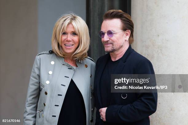 Brigitte Trogneux , Emmanuel Macron's wife, welcomes Bono , singer of U2 and cofounder of the NGO One, as he arrives to meet French President at the...