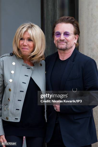 Brigitte Trogneux , Emmanuel Macron's wife, welcomes Bono , singer of U2 and cofounder of the NGO One, as he arrives to meet French President at the...