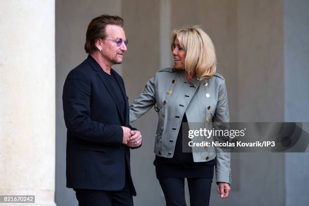 Brigitte Trogneux , Emmanuel Macron's wife, welcomes Bono , singer of U2 and cofounder of the NGO One, as he arrives to meet French President at the...