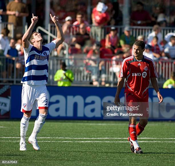 Defender Marco Velez of Toronto FC watches as forward Kenny Cooper of FC Dallas celebrates his second goal of the match on August 3, 2008 at BMO...