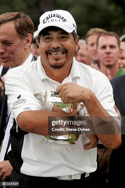 Eduardo Romero hugs the US Senior Open trophy on the 18th green after winning the US Senior Open Championship at the Broadmoor on August 3, 2008 in...