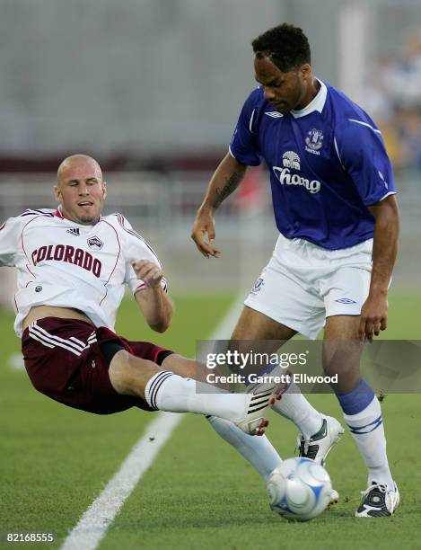 Conor Casey of the Colorado Rapids controls the ball against Joleon Lescott of Everton FC at Dick's Sporting Goods Park on August 3, 2008 in Commerce...