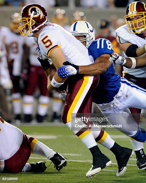 Defensive end Curtis Johnson of the Indianapolis Colts sacks quarterback Colt Brennan of the Washington Redskins in the Pro Football Hall of Fame...