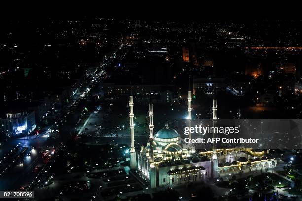 Picture taken late on July 24, 2017 shows the Heart of Chechnya mosque and the avenue named after Russian President Vladimir Putin in central Grozny....