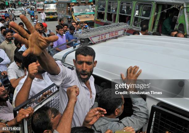 Supporter of Independent MLA Engineer Rashid shouts slogan as policemen detained him during his protest march against the beating of policemen by...
