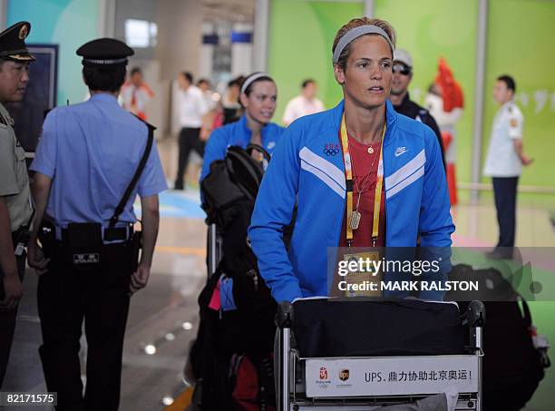 Swimmer Dara Torres arrives at the Beijing International airport for the Olympic Games on August 4, 2008. The US swim team are chomping at the bit in...