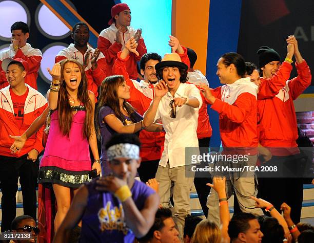 Host Miley Cyrus, Mandy Jiroux and Adam Sevani onstage during the 2008 Teen Choice Awards at Gibson Amphitheater on August 3, 2008 in Los Angeles,...