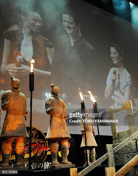 Hong Kong actress Isabella Leong , US actor Brendan Fraser and Malaysian actress Michelle Yeoh are seen on a screen beside replicas of the Terracotta...