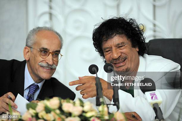 Libyan leader Moamer Kadhafi shares a laugh with Tunisian minister of Culture & Protection of National Heritage Mohamed Aziz Ben Achour during a...