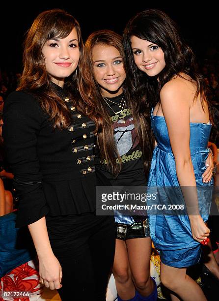 Host Miley Cyrus with Demi Lovato and Selena Gomez during the 2008 Teen Choice Awards at Gibson Amphitheater on August 3, 2008 in Los Angeles,...