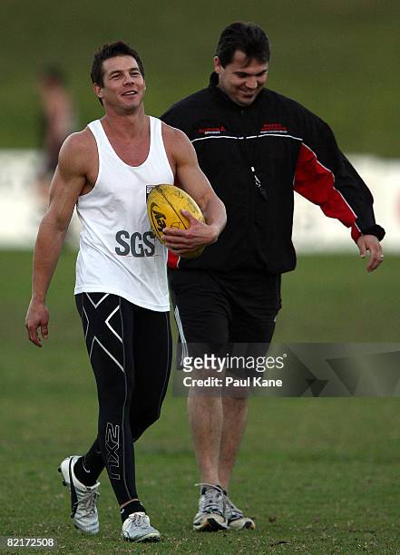 Disgraced former AFL player Ben Cousins talks with a Perth Demons coaching staff member during a training session with WAFL club Perth Demons at...