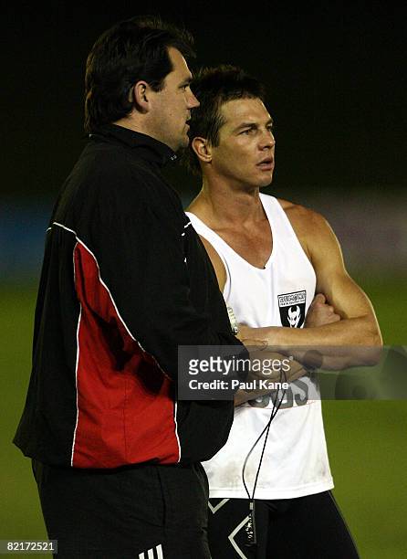 Disgraced former AFL player Ben Cousins talks with a Perth Demons coaching staff member during a training session with WAFL club Perth Demons at...