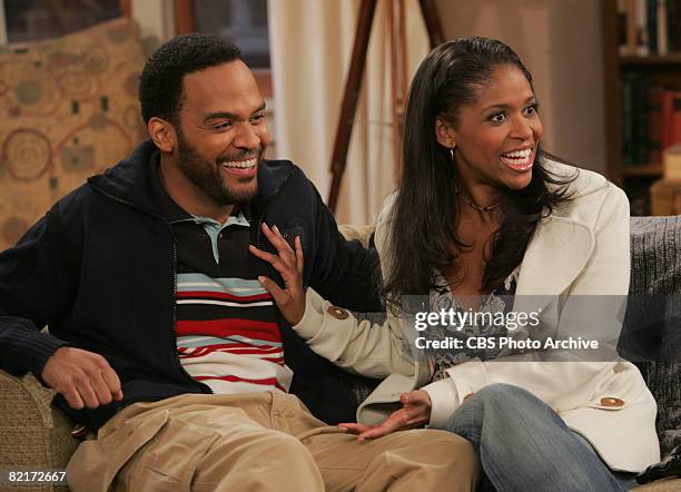 American actors Victor Williams and Merrin Dungey, as Deacon and Kelly Palmer, smile in a scene from an episode of the television comedy 'The King of...