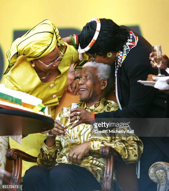 Former South African President Nelson Mandela flanked by his former wife Winnie Mandela and current wife Graca Machel attend the ANC Madiba 90th...