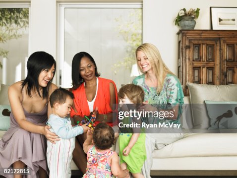 Three mothers and their children playing together Three mothers and their children playing together