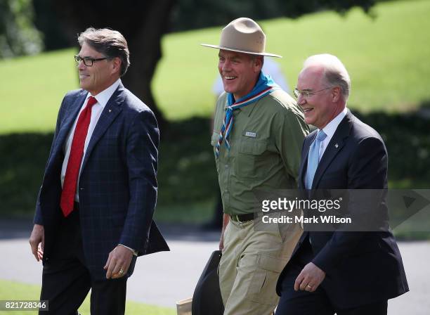Energy Secretary Rick Perry, Interior Secretary Ryan Zinke, and HHS Secretary Tom Price walk to Marine One to depart with U.S. President Donald Trump...