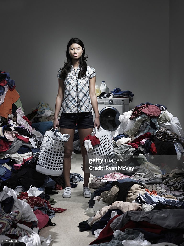 Woman standing in overflowing laundry room