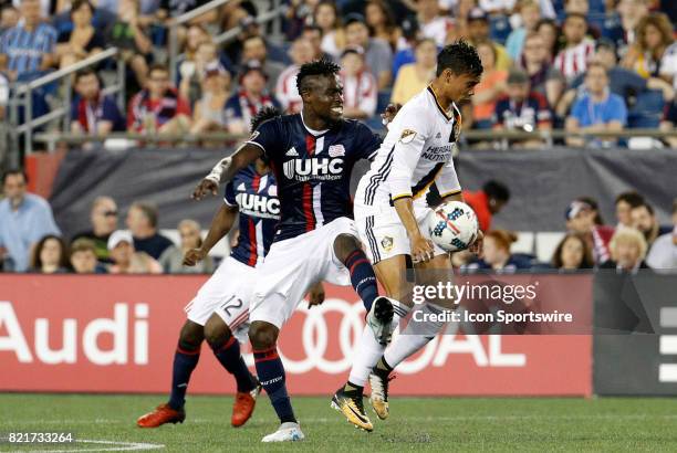 Los Angeles Galaxy forward Ariel Lassiter is fouled by New England Revolution midfielder Gershon Koffie during a regular season MLS match between the...