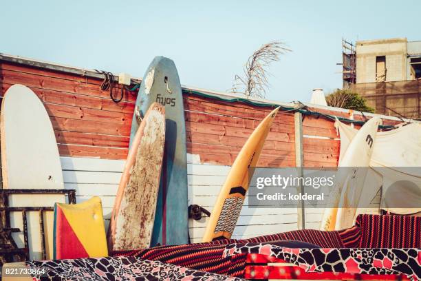 Surfboards Leaning On The Wall Illuminated By Sunset Light High-Res Stock Photo