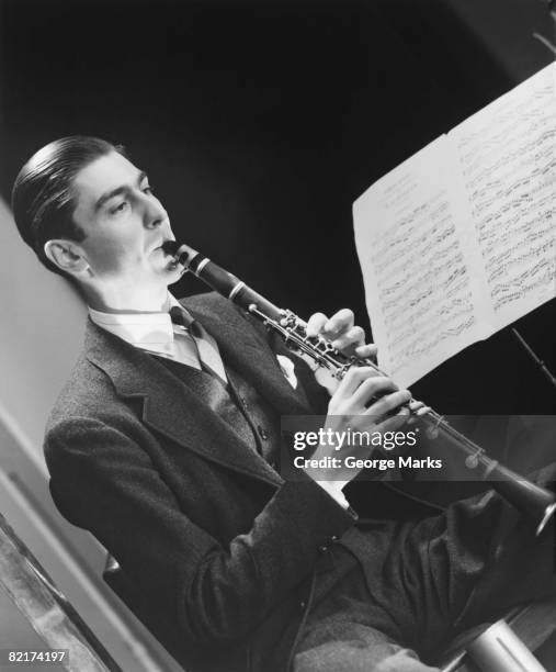 man playing oboe, (b&w) - oboe stockfoto's en -beelden