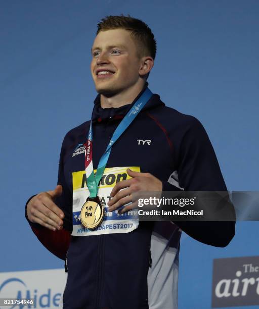 Adam Peaty of Great Britain poses with his gold medal from the final of Men's 100m Breaststroke on day eleven of the FINA World Championships at the...