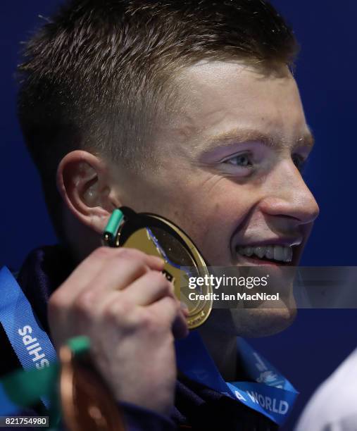 Adam Peaty of Great Britain poses with his gold medal from the final of Men's 100m Breaststroke on day eleven of the FINA World Championships at the...