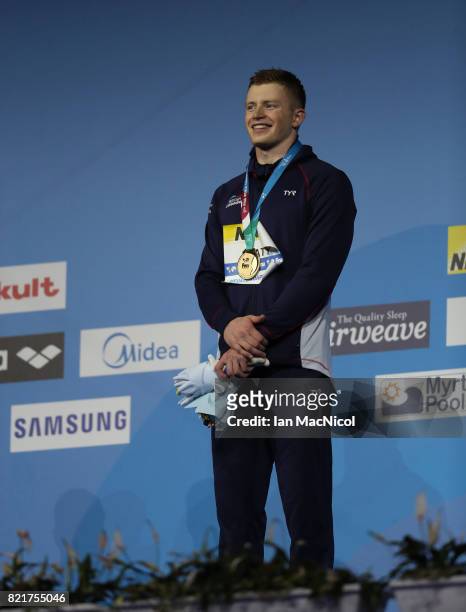 Adam Peaty of Great Britain poses with his gold medal from the final of Men's 100m Breaststroke on day eleven of the FINA World Championships at the...