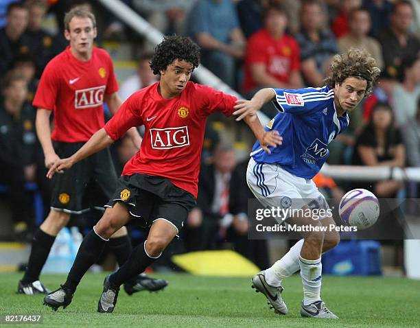 Rafael Da Silva of Manchester United clashes with Sergio Torres of Peterborough United during the pre-season friendly match between Peterborough...