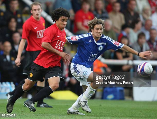 Rafael Da Silva of Manchester United clashes with Sergio Torres of Peterborough United during the pre-season friendly match between Peterborough...