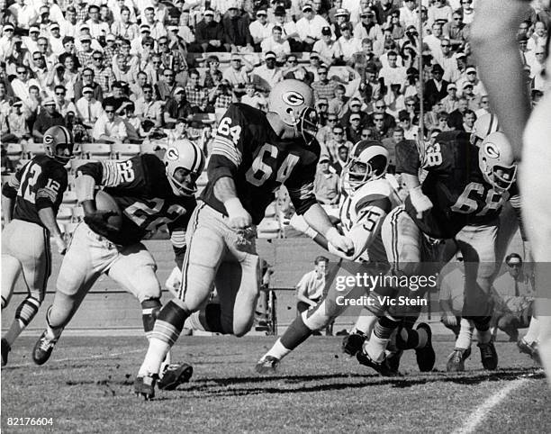 Green Bay Packers guard Jerry Kramer leads runnng back Elijah Pitts in a 1960s game against the Los Angeles Rams.
