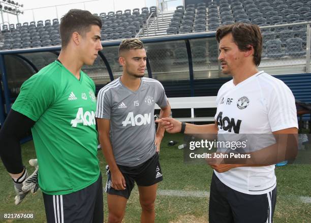 Joel Pereira and Andreas Pereira of Manchester United talk to Assistant Manager Rui Faria during a first team training session as part of their...