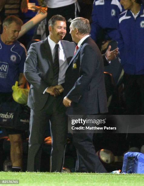 Sir Alex Ferguson of Manchester United shakes hands with his son Darren Ferguson of Peterborough United after the pre-season friendly match between...
