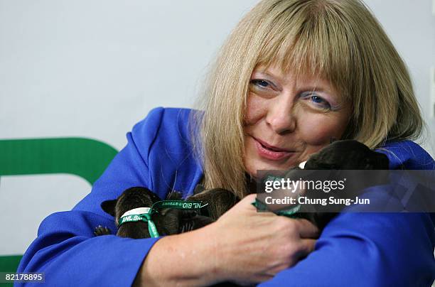 Bernann Mckinney, a pet owner holds her pit bull terrier cloned dogs at the Seoul National University on August 5, 2008 in Seoul, South Korea. The...