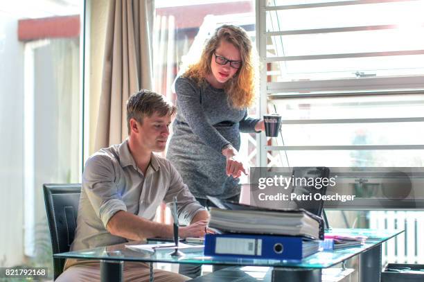 a young pregnant woman delegating to an employee. - delegating stock pictures, royalty-free photos & images