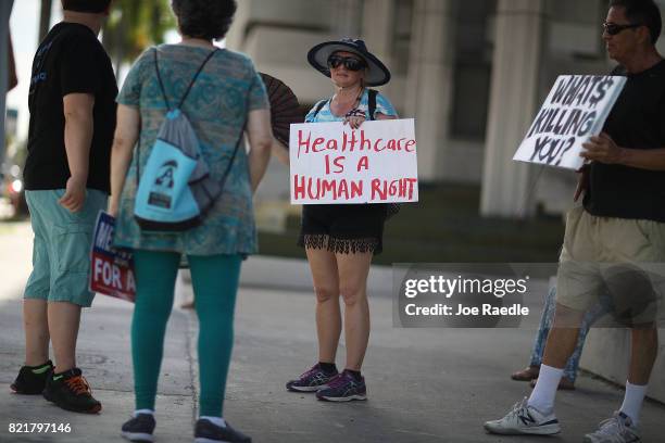 Katrina Greenwood joins with other protesters against Republican senators who have not spoken up against Affordable Care Act repeal and demand...